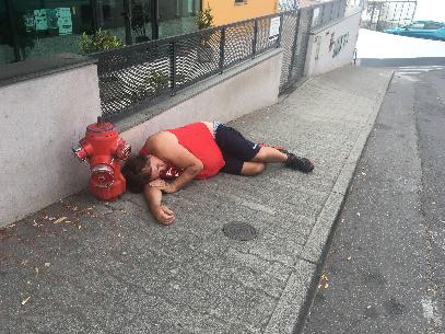 Man Sleeping on Pavement